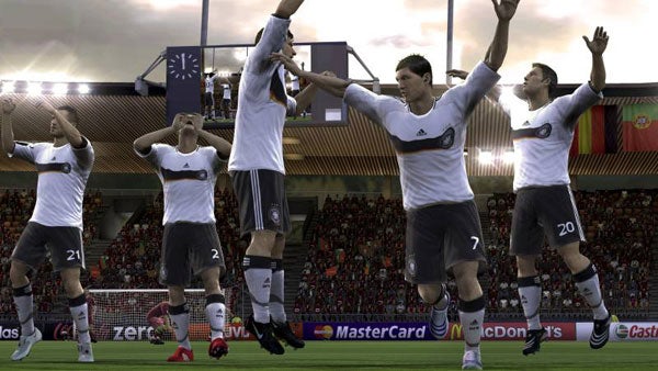 Video game screenshot of players celebrating a goal at UEFA Euro 2008.Video game screenshot of footballers celebrating a goal.