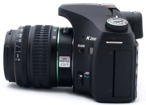 Pentax K200D DSLR with lens on white background.Pentax K200D DSLR camera with lens attached.