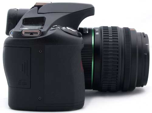 Pentax K200D digital SLR camera with lens attached.Pentax K200D DSLR camera with lens on white background.