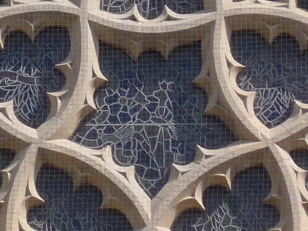 Close-up of architectural stone patterns with intricate designsClose-up of intricate stone lattice work on a building facade.