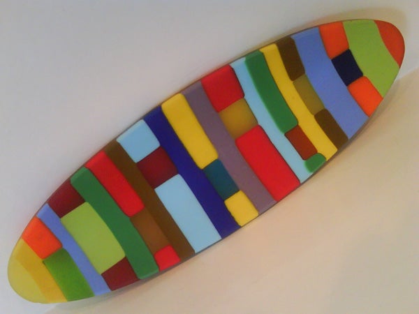 Colorful abstract mosaic artwork on oval shape.Colorful surfboard-shaped object with geometric patterns.