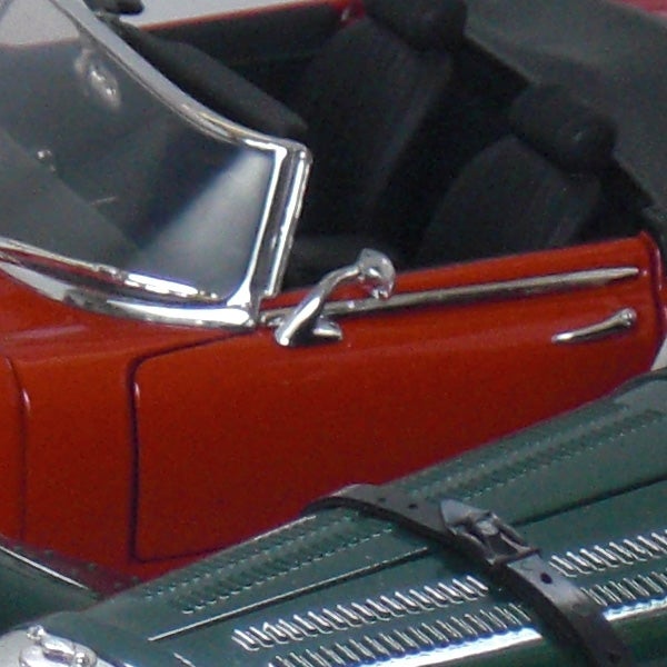 Close-up of vintage toy cars in red and green colors.