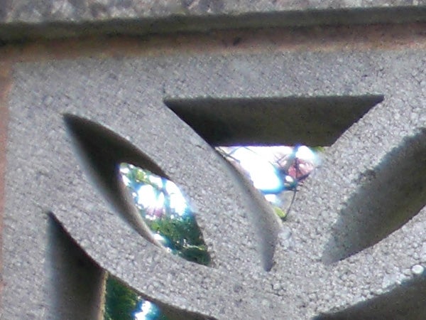 Close-up of a decorative concrete structure with backgroundClose-up of concrete with triangular and leaf-shaped cut-outs.