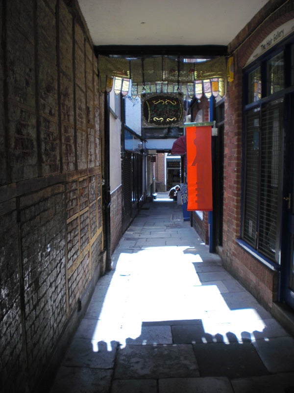 Narrow alleyway with contrasting shadows and sunlight.Narrow alleyway with sunlight and shadows.