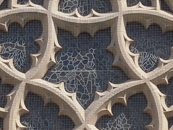 Close-up of architectural detail showing camera's high-resolution capture capabilityClose-up of intricate stone lattice work with floral patterns.