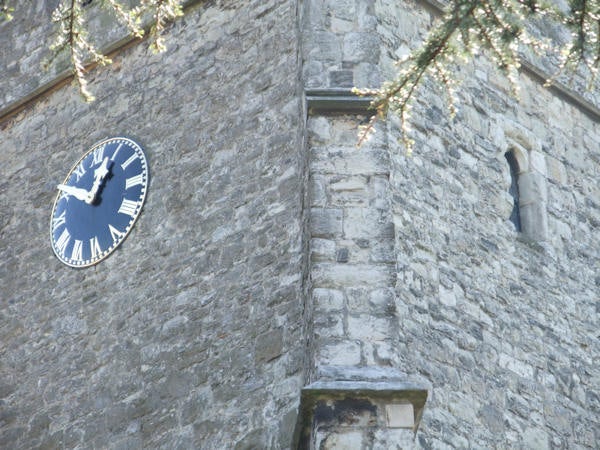 Clock on stone tower captured with Fujifilm Finepix F100fd.Photograph of a clock on a stone tower taken with Fujifilm Finepix F100fd.