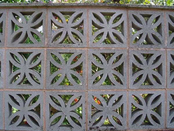 Decorative concrete block wall with geometric pattern.Decorative concrete block wall with a floral pattern.