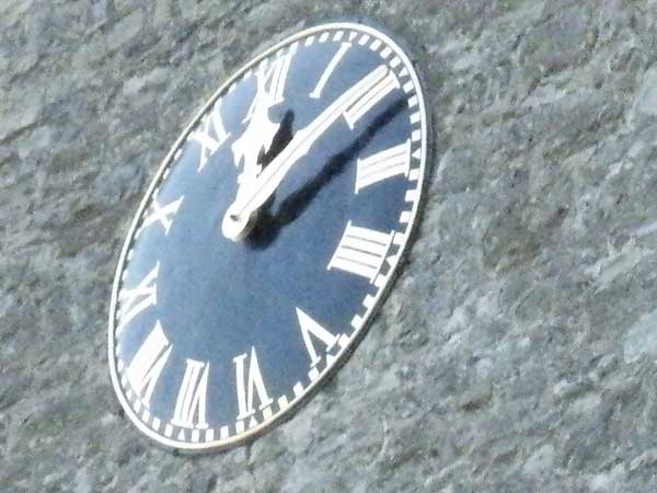 photo of a clock face taken with Fujifilm Finepix S8100fd.photo of a clock face on a rock surface.