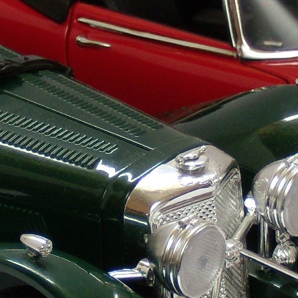 Close-up photo of vintage model carsClose-up photo of a green vintage toy car with red car in background