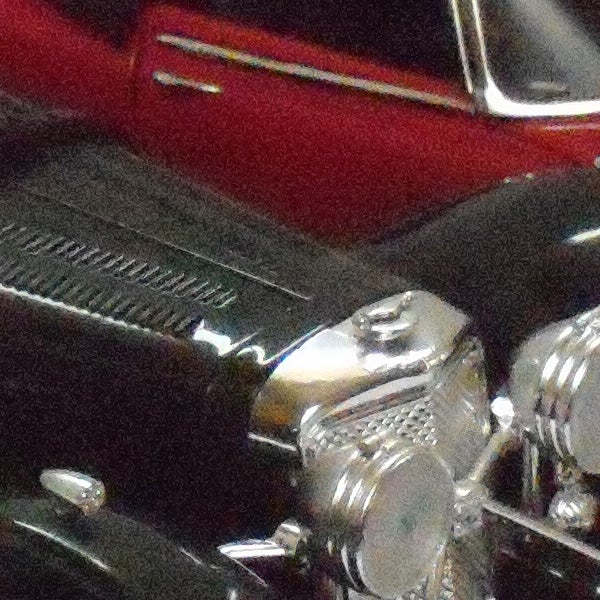 Close-up photo of a red classic car and chrome details.Close-up of a classic car captured with Nikon CoolPix P60.
