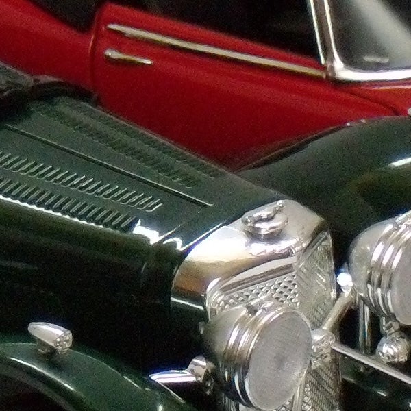 Close-up of a classic car hood and headlights.Close-up of a vintage car captured with Nikon CoolPix P60.
