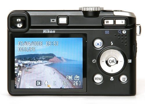 Nikon CoolPix P60 camera with a photo on display screen.Nikon CoolPix P60 camera displaying a beach photo on its screen.