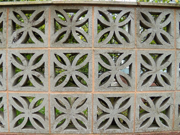 Decorative concrete block wall with geometric patterns.Decorative concrete block wall with a leaf-like pattern.