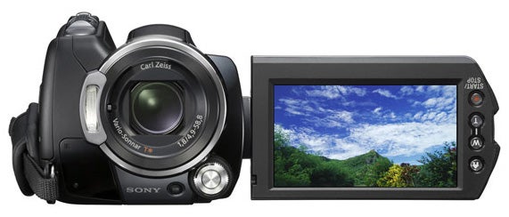 Sony HDR-SR12E camcorder with flip-out LCD screen displaying landscape.Sony HDR-SR12E camcorder with open LCD screen displaying scenic view.