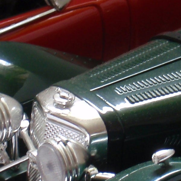 Close-up of a vintage car model.Classic green car model close-up photograph.
