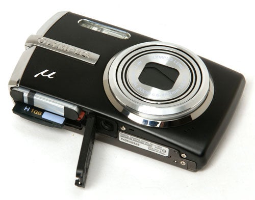 Olympus mju 1010 compact camera with memory card slot open.Olympus mju 1010 digital camera with memory card slot open.