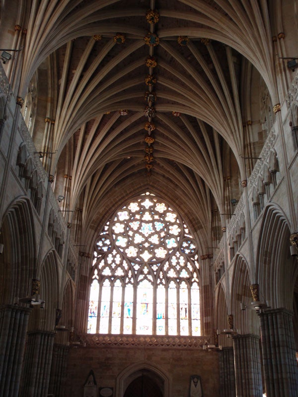Gothic cathedral interior with vaulted ceiling and stained-glass window.Interior of a cathedral with vaulted ceilings and stained glass window.