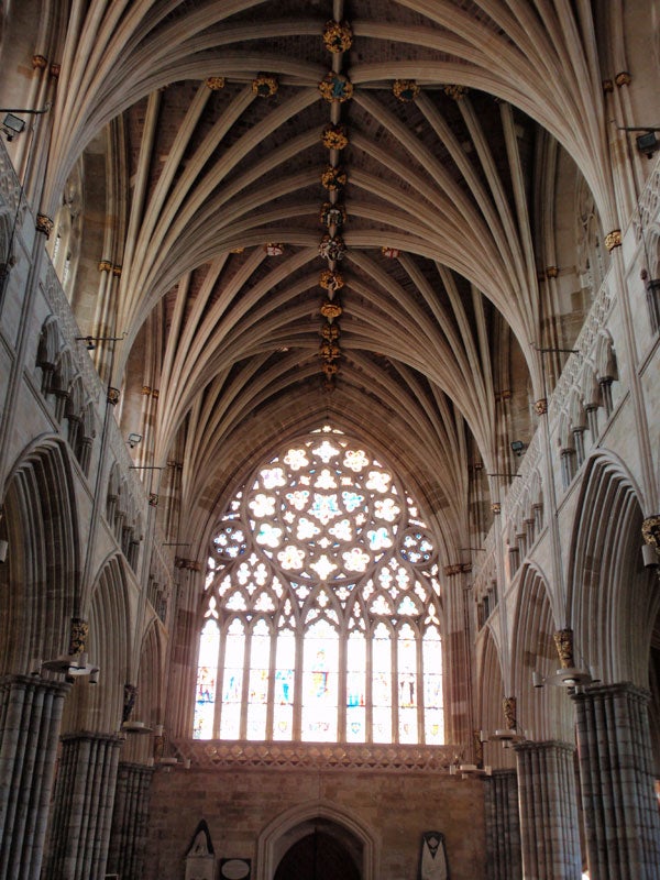 Gothic cathedral interior with vaulted ceilings and stained glass.Gothic cathedral interior with ornate vaulted ceiling and stained glass window.