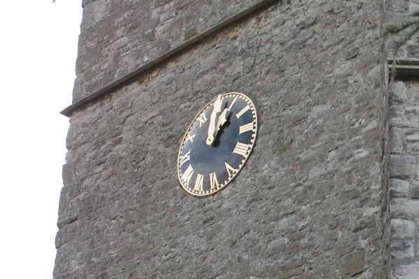Clock on stone tower taken with Sigma DP1 camera.Old tower clock displaying time at ten past ten.