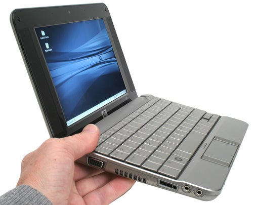 Hand holding an open HP 2133 Mini-Note PC with Linux.Hand holding an open HP 2133 Mini-Note PC.