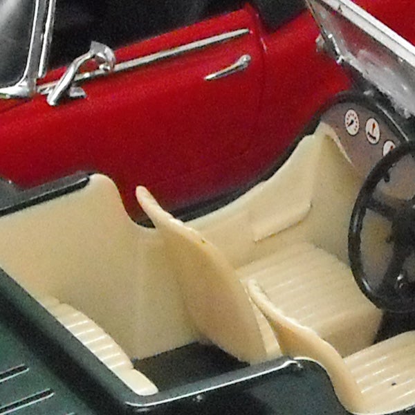 Close-up of a vintage red car toy interiorClose-up of a classic red car model interior