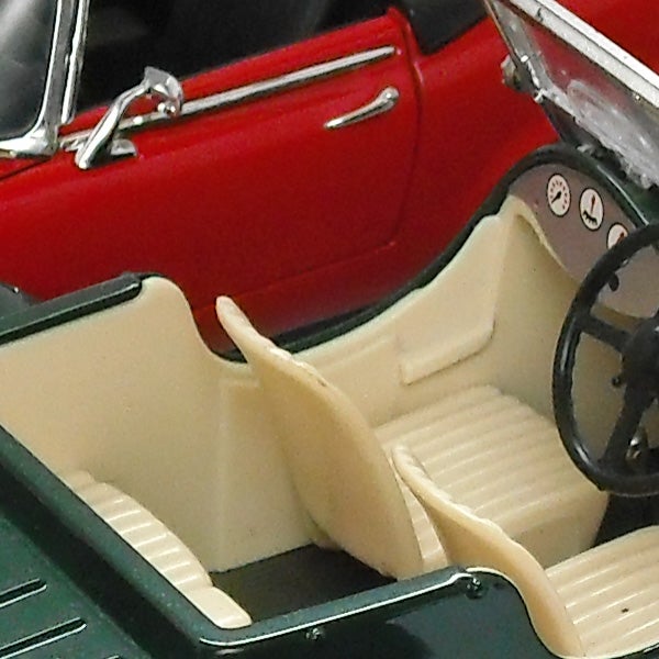 Close-up of a red vintage toy convertible car interior.Close-up of a model car interior with a red exterior.
