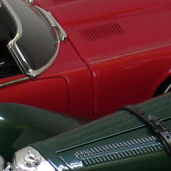 Close-up of vintage red and green toy cars.Close-up of red and green vintage toy cars.