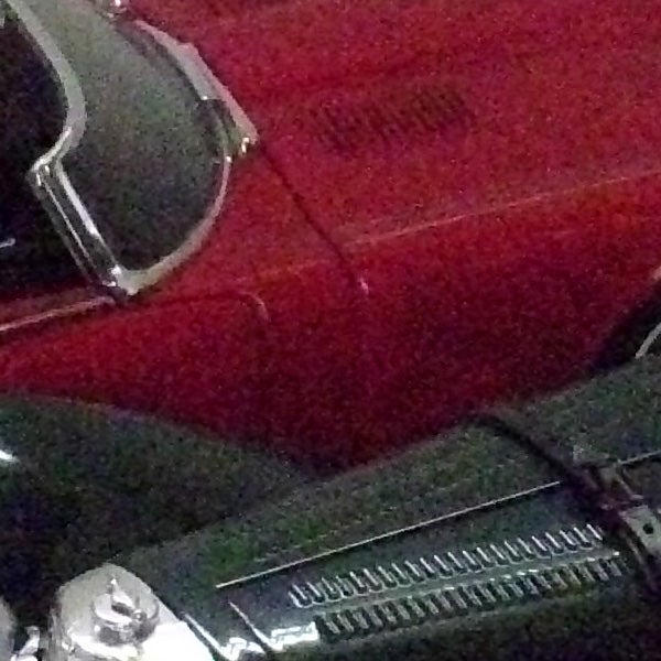 Close-up of a red car photographed with BenQ DC C850.Close-up of red car's exterior and vintage details.