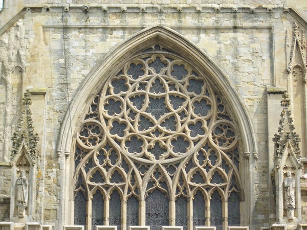 Ornate Gothic church window architecture.Intricate gothic window architecture on a cathedral facade.