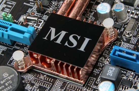 Close-up of MSI logo on a copper heatsink amidst motherboard components.Close-up of MSI P45 Platinum motherboard chipset with heatsink.