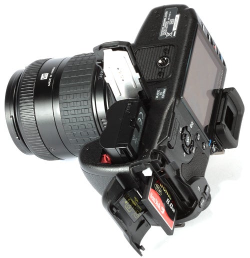 Olympus E-520 DSLR camera with open memory card slot.