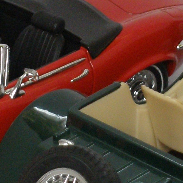 Close-up of a detailed model car showing vibrant colors.Close-up of a red and green toy car.
