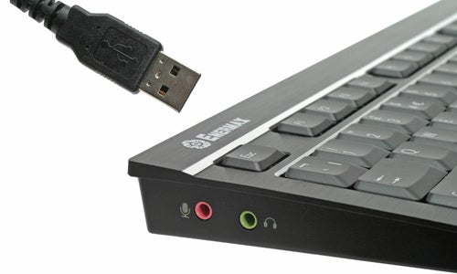Close-up of Enermax Aurora keyboard and USB connector.Enermax Aurora Premium keyboard with USB connector and audio ports.