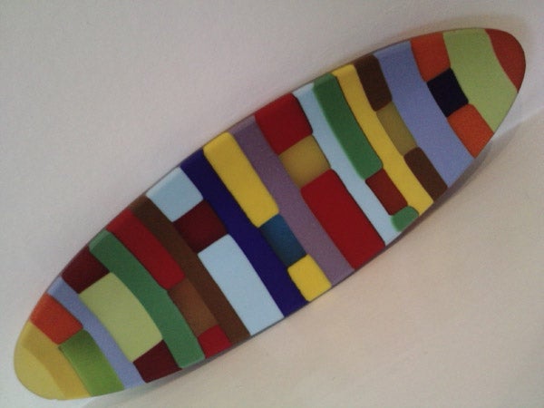Colorful abstract pattern on a surfboard-shaped object.Colorful abstract pattern on a skateboard deck