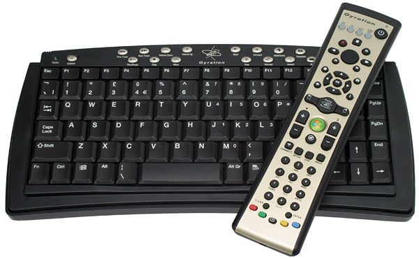 Gyration wireless keyboard and media remote on white surface.