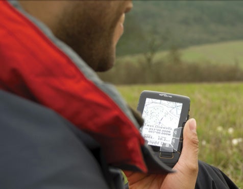 Person holding Satmap Active 10 GPS outdoors.