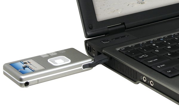 Creative Vado Pocket Video Cam connected to a laptop via USB cable.