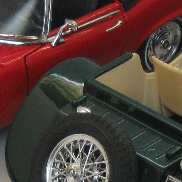 Close-up of red vintage car and green toy car.Close-up of a model car captured with Canon PowerShot A590 IS.