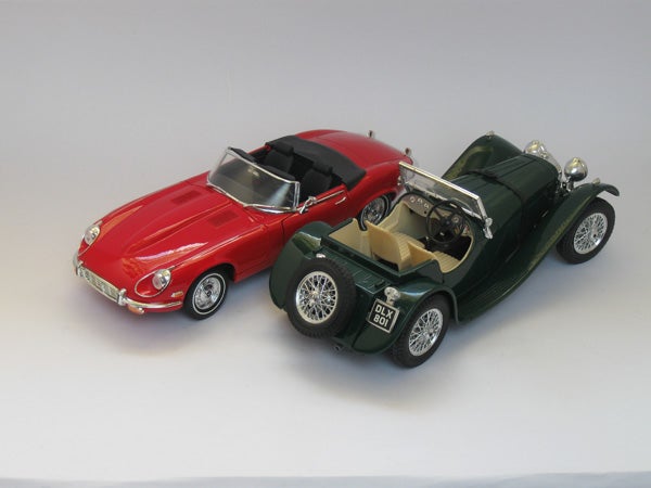 Photo of two model cars on a white background.Toy model cars photographed on a plain background.