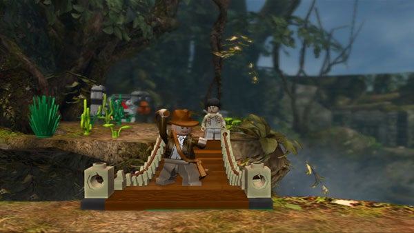 Screenshot of Lego Indiana Jones video game gameplay.Lego Indiana Jones game screenshot with characters on a bridge.