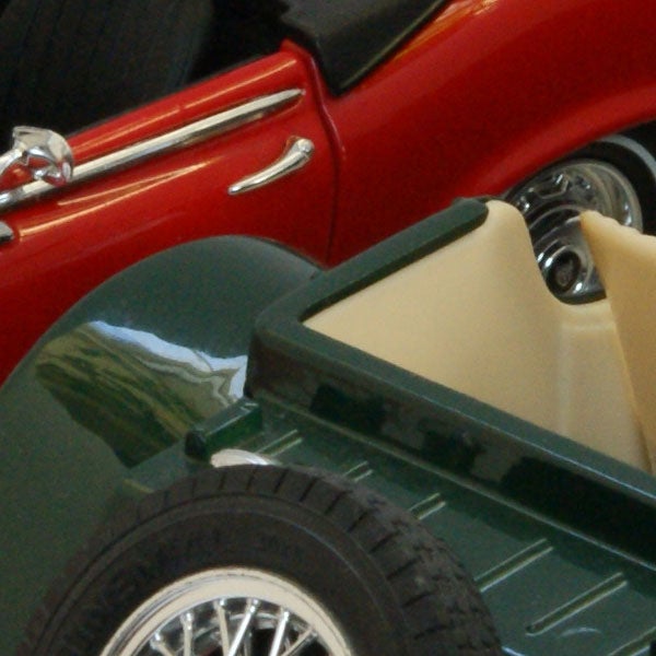 Close-up of red and green model carsClose-up of model cars with focus on detailed textures.