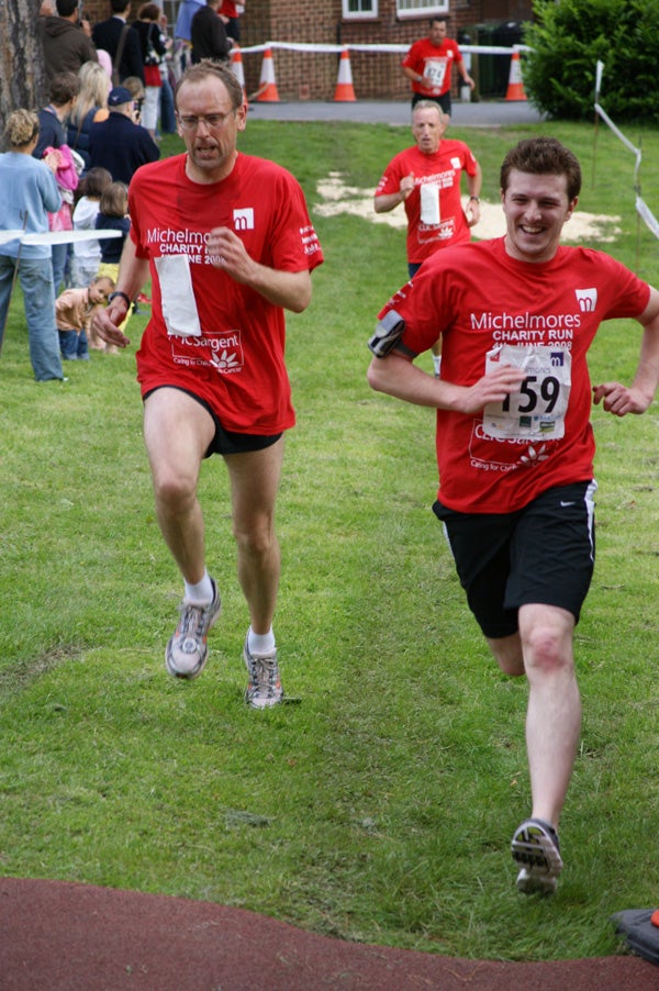 Two runners competing in charity race event.Two runners participating in a charity race event