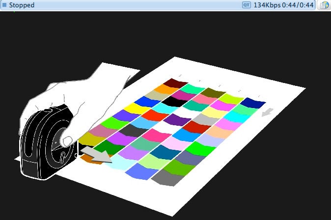 Color calibration device scanning a printed color chart.