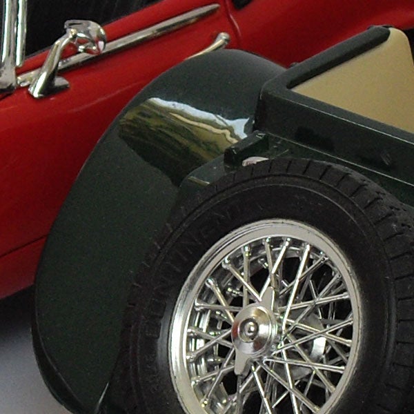 Close-up of a vintage car's wheel and fender.Detail of a model car wheel and fender.