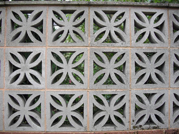 Decorative concrete wall with symmetrical patterns.Decorative concrete block wall with geometric patterns.