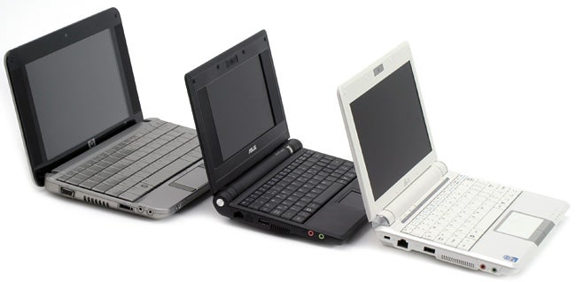 Three Asus Eee PC 901 laptops in black and white colors.