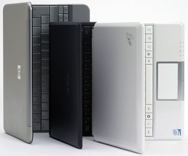 Asus Eee PC 901 netbooks in three different colors.Three Asus Eee PC 901 laptops in black, bronze, and white.