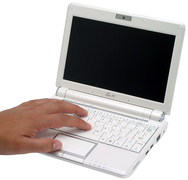 Asus Eee PC 901 laptop with a hand on its keyboardHand on Asus Eee PC 901 netbook with a white keyboard.