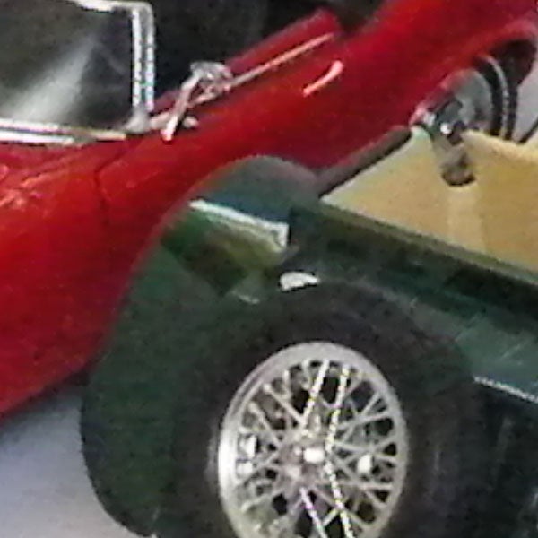 Close-up of vintage toy cars with focusClose-up of a toy car's wheel and fender.
