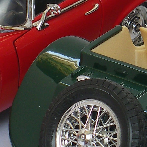 Model cars with reflection of landscape in chrome bumper.Close-up of model cars with reflective surfaces.